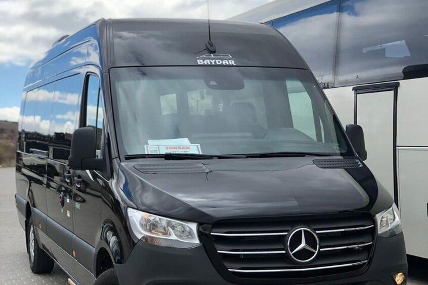 A black Mercedes-Benz camper van with a 'Baydar' logo on the windshield. 4
