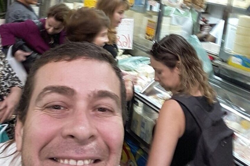 A person in a store aisle with shelves stocked with products. 2