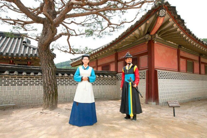 A traditional Korean building with a tiled roof and wooden walls, a tree in the foreground, and a person in traditional attire. 4