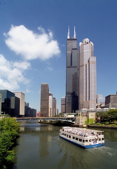 A river with a boat and a city skyline in the background. 5