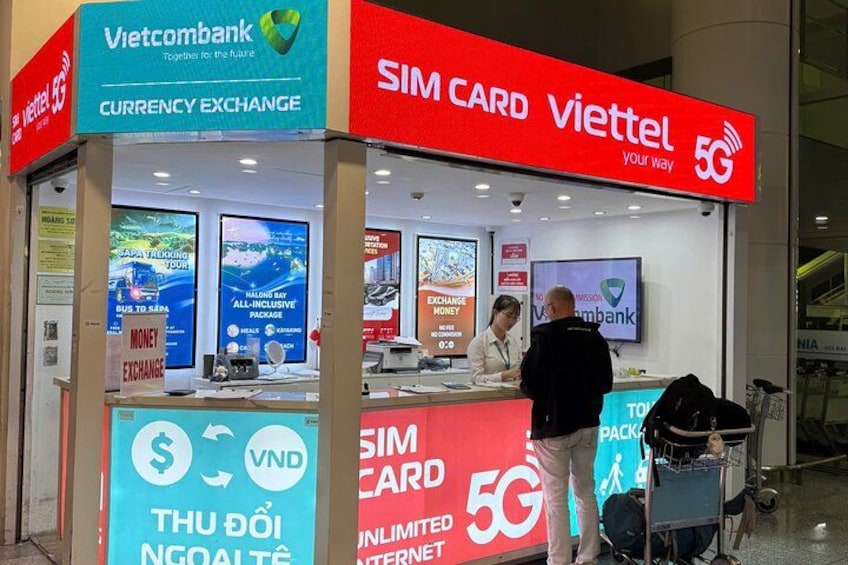 A currency exchange and SIM card kiosk at an airport. 3