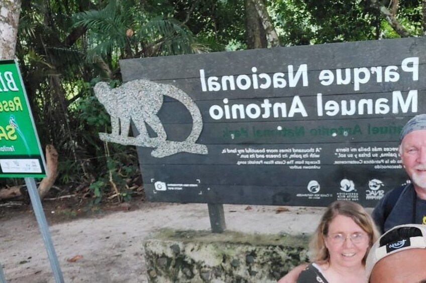 A sign with a kangaroo and a woman and a man in the foreground. 2