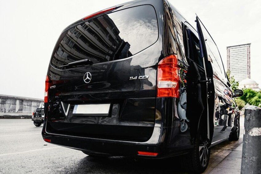 A black Mercedes-Benz Sprinter van with the license plate '114 CDI' on a highway. 3