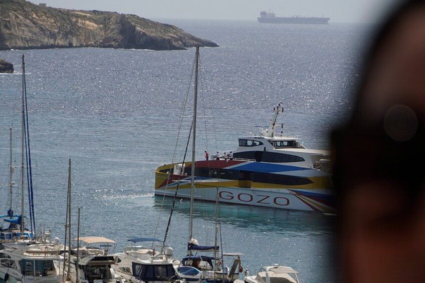 A harbor with multiple boats, including a prominent yellow and blue boat named 'GOZO.' 2