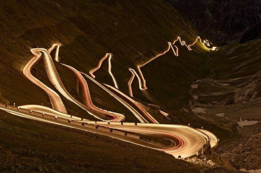 A winding road through a mountainous landscape at night. 2