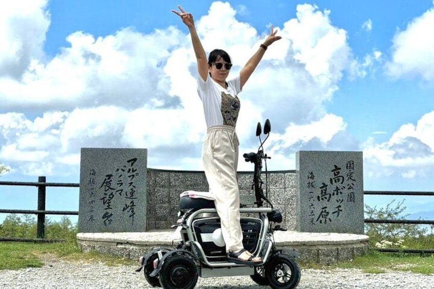 A person standing on a Segway in front of a stone monument with inscriptions. 2