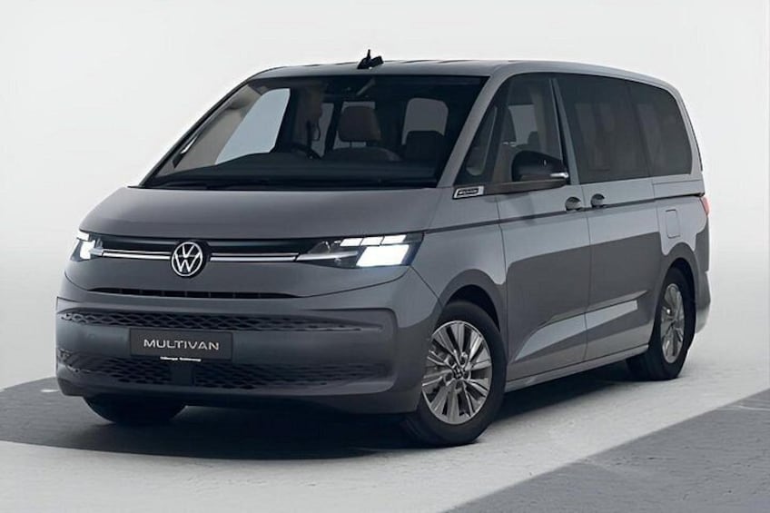 A gray Volkswagen Multivan parked on a flat surface. 1