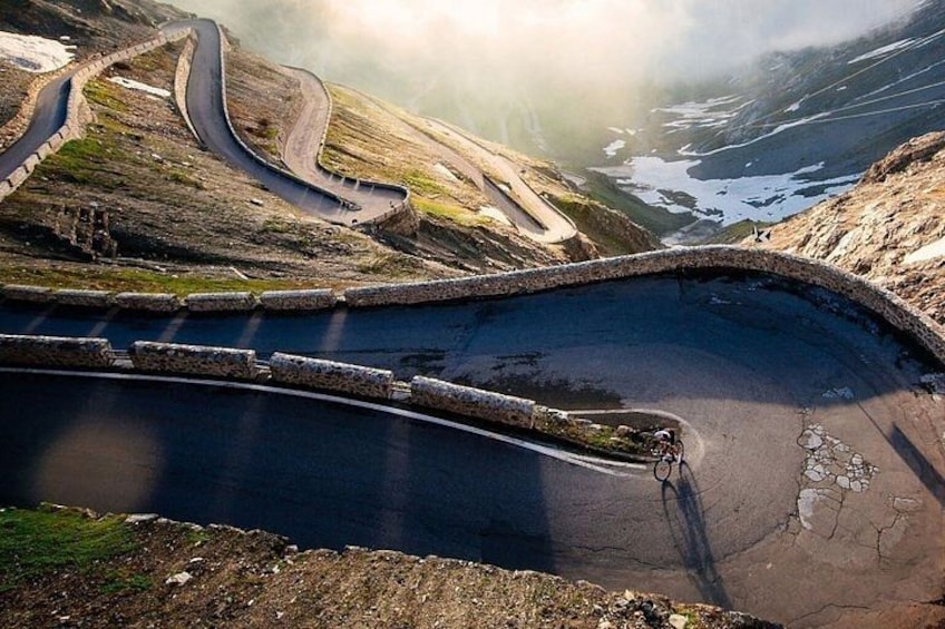 A winding mountain road with a cyclist. 5