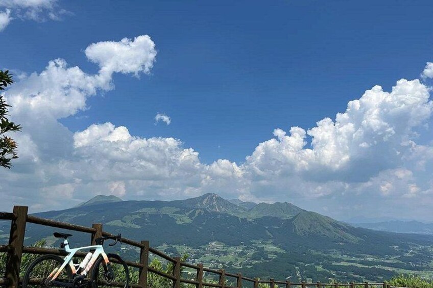 A mountain landscape with a wooden fence and a bicycle. 3