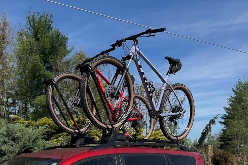 A bicycle rack on a car with two bicycles. 3