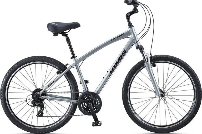 A stationary bicycle with a black seat, silver frame, and black tires. 3