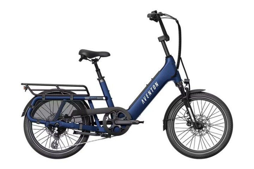 A blue electric bicycle with a basket, a seat, and a handlebar. 1