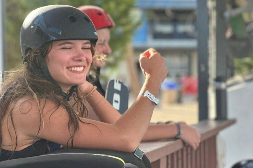 A person wearing a helmet and a watch, sitting outdoors. 5