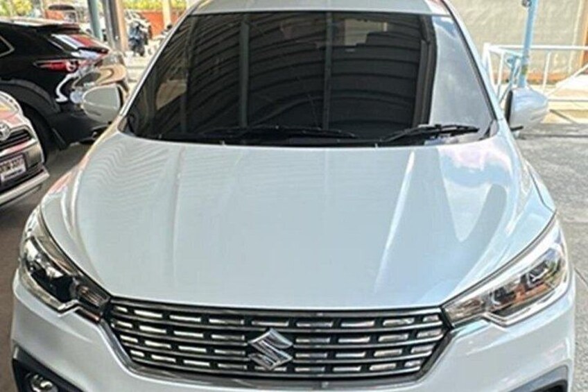 A white car with a distinctive front grille and headlights. 1