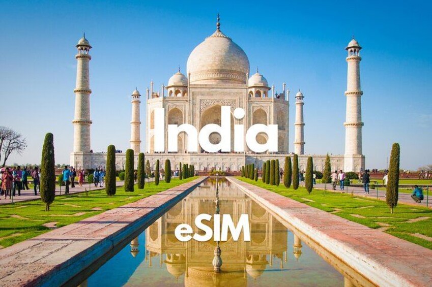 The Taj Mahal with a reflection in the water, surrounded by manicured gardens and visitors. 1