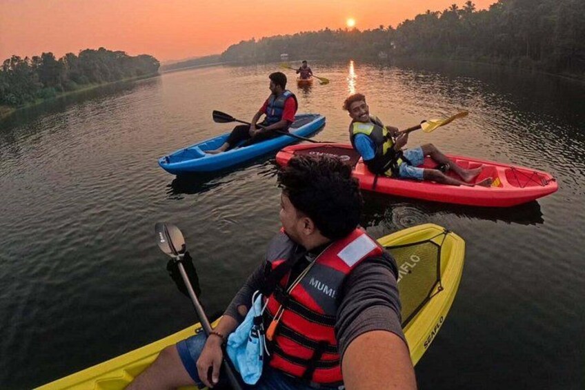 People kayaking on a river during sunset. 1