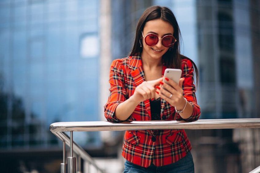 A person in a red plaid shirt using a smartphone. 2
