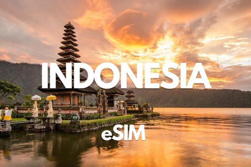 A traditional Indonesian temple by a calm lake during sunset. 1