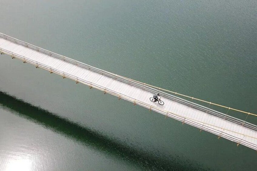An aerial view of a bridge with a cyclist on it. 1