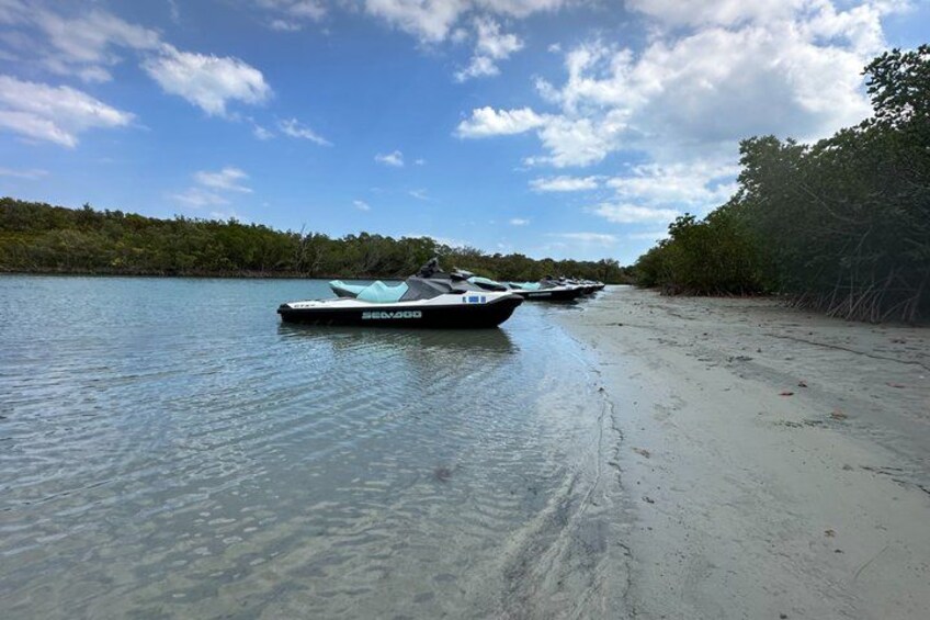 A calm lake with a boat named 'SEAAGO' docked on the shore. 4