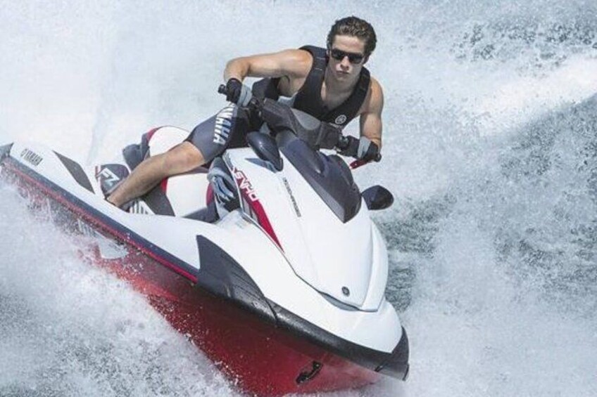A person riding a jet ski on water. 1