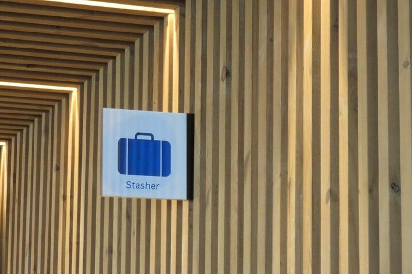 A wooden wall with vertical slats and a sign indicating a stasher. 4