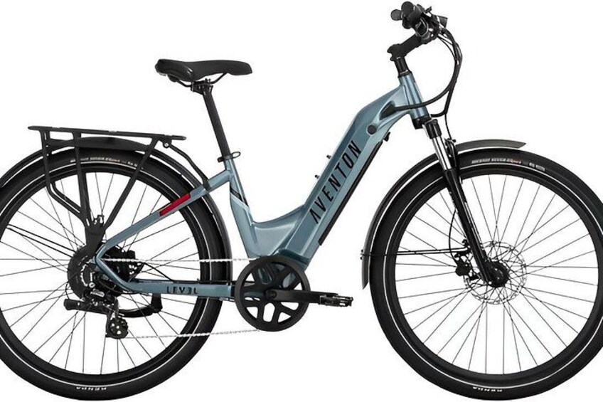 A stationary electric bicycle with a black and gray frame, a rear rack, and a front suspension fork. 1