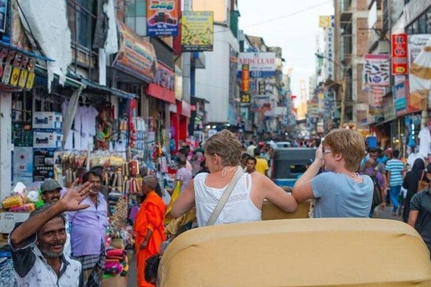 A crowded street with shops and people. 1