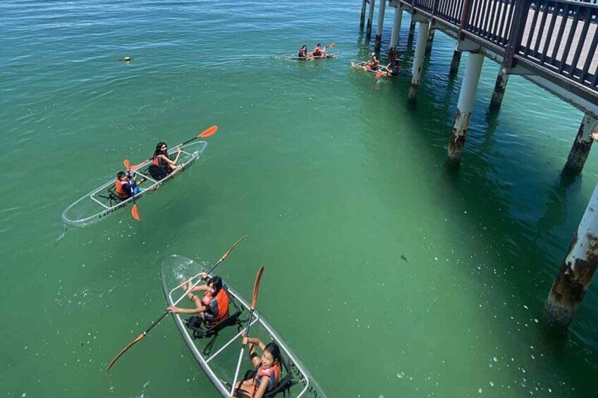 Two kayaks on calm water near a pier. 4