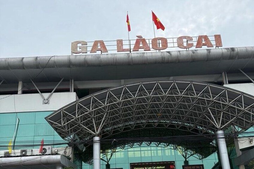 A stadium entrance with the text 'GA LÀO CAI' and two flags. 5