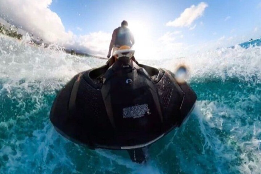 A person riding a jet ski on a body of water with waves. 3