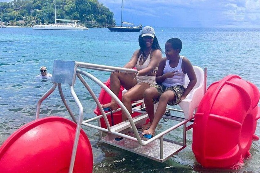 A boat with two people and a red buoy in the water. 4