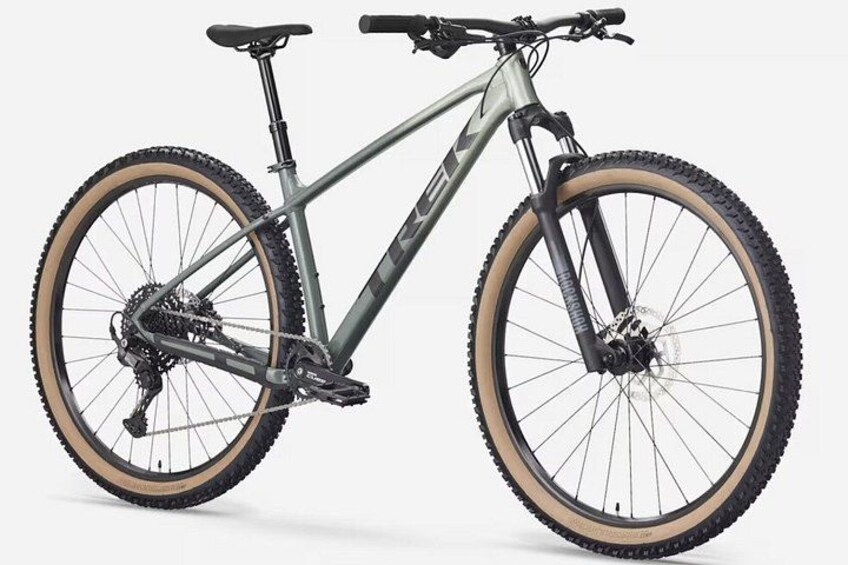 A mountain bike with a front suspension fork, a gear shifter, and a rear derailleur. 1