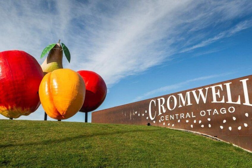 A sign for Cromwell Central Otago with large fruit sculptures. 4