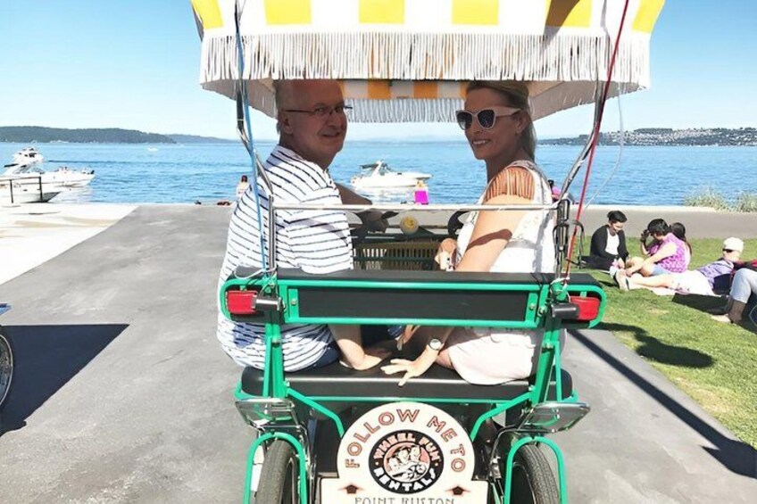 A green cart with a sign that reads 'HOW TO' and 'PONT BRITAN' parked by the water. 5