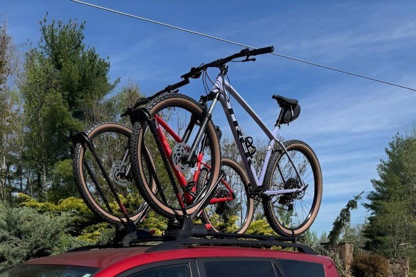 A bicycle rack on a car with two bicycles. 4