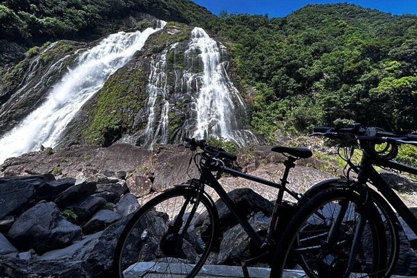 A waterfall, a bicycle, and a rocky terrain. 4