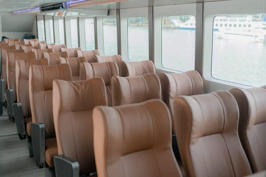 Rows of brown leather seats on a boat. 5