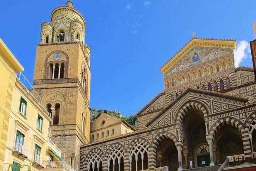 A historic building with intricate architecture, including a tower and detailed facade. 4