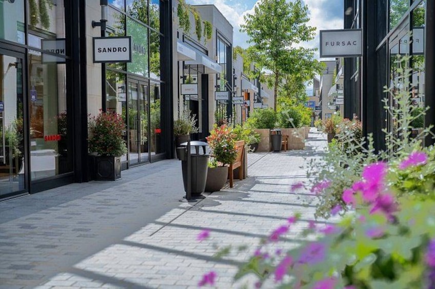 A pedestrian street lined with storefronts, including 'Sandro' and 'Fursac'. 3