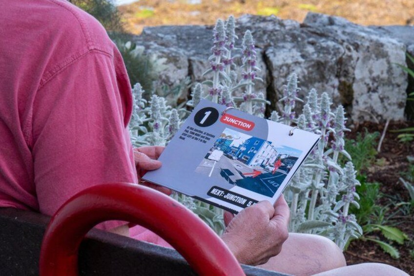 A person holding a booklet titled 'JUNCTION' with a cityscape illustration. 5