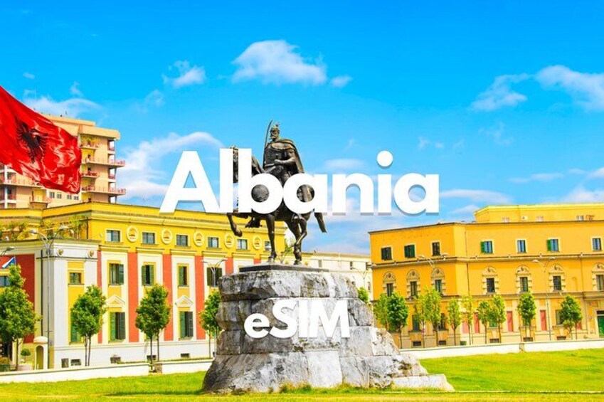 A statue in a square with buildings in the background. 1