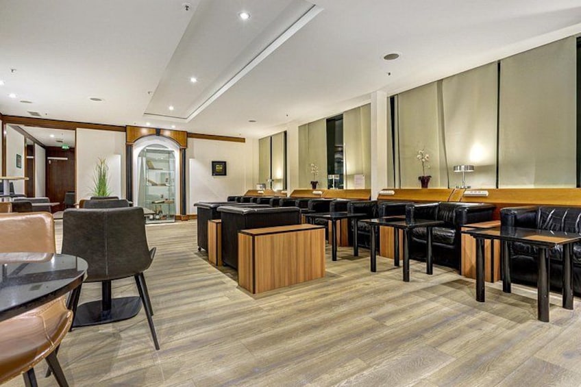 A modern interior with a reception desk, leather seating, and a wooden floor. 5