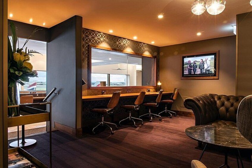 A modern interior with a bar area, seating, and a television. 3