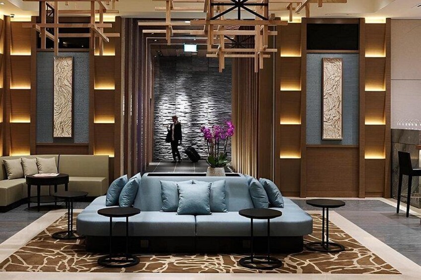 A modern lounge with a sofa, tables, and decorative panels. 5
