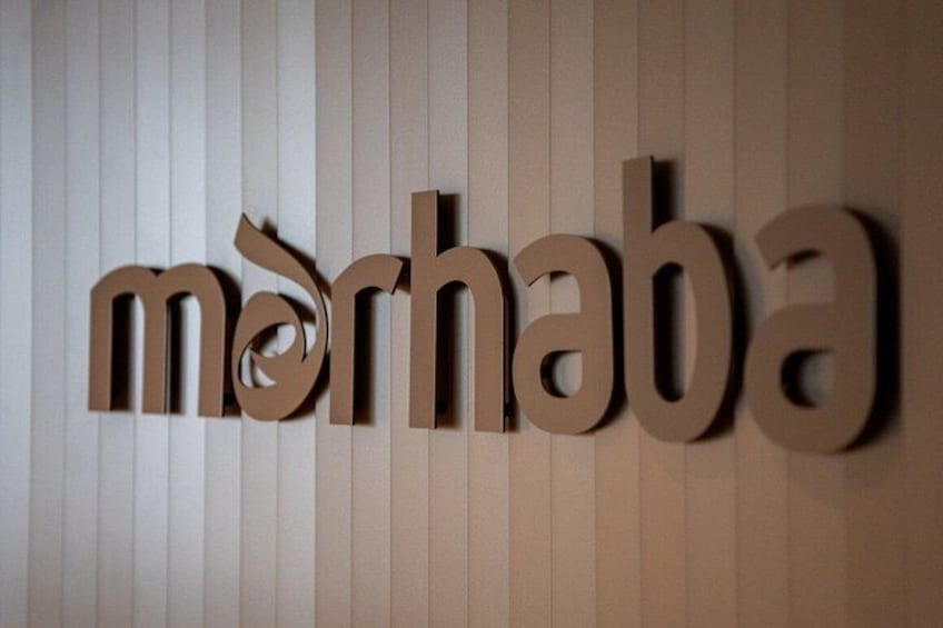 A wooden sign with the word 'mörhana' on a vertical striped background. 3