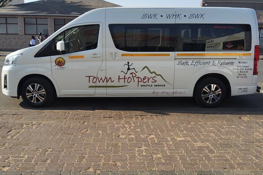 A white van with 'Town Hoppers' branding and 'Safe, Efficient & Reliable' slogan. 5