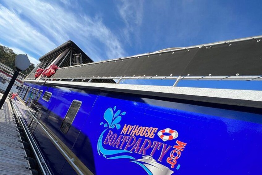 A blue boat with 'MYHOUSE BOAT PARTY' written on its side. 2
