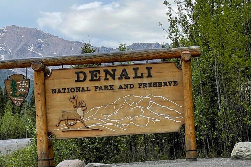 A wooden sign for Denali National Park and Preserve with a mountain silhouette. 4