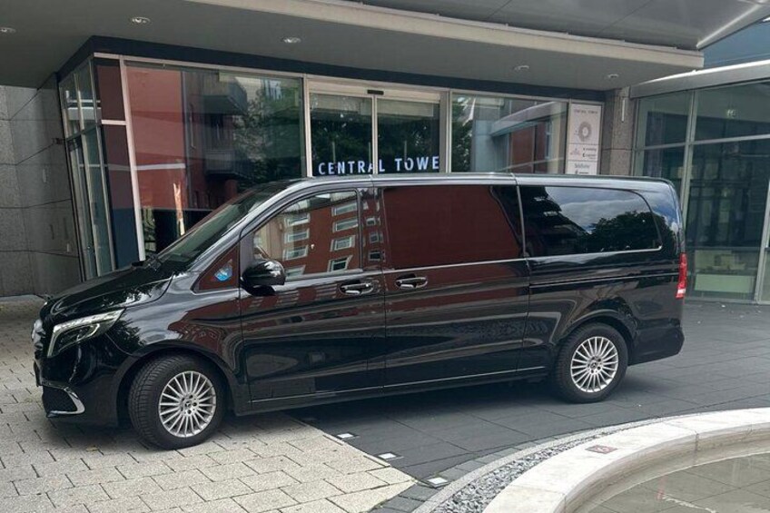 A black van parked in front of a building with a sign that reads 'CENTRAL TOW'. 4